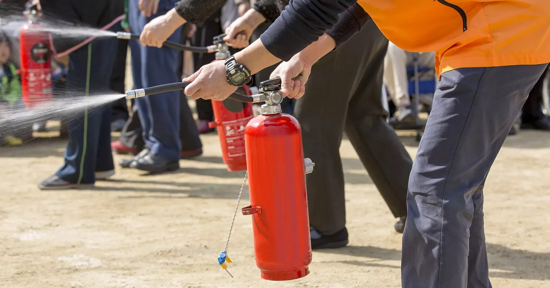 Technician inspecting a fire safety system by fire safety compliance company in Oman